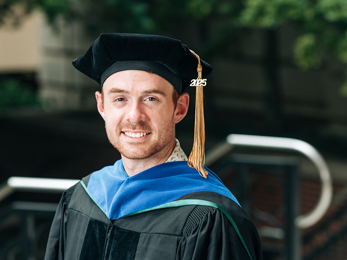 A headshot of Josh Huffines in his doctoral commencement regalia.