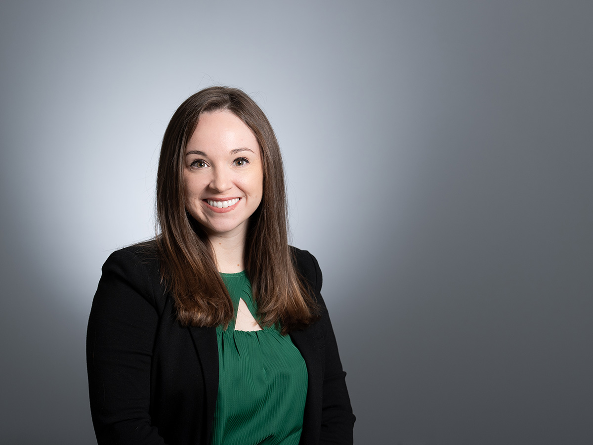 Headshot of Dr. Stephanie Wilson in green top and black jacket