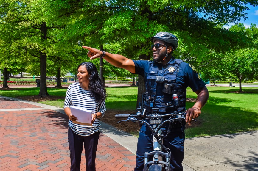 UAB Police Officer patrolling on a bicycle talking to student