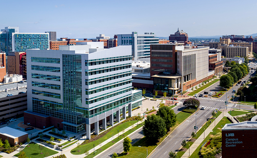 Aerial view of the new research building on UAB's campus and other campus buildings in the background along with a stretch of University Boulevard in the foreground
