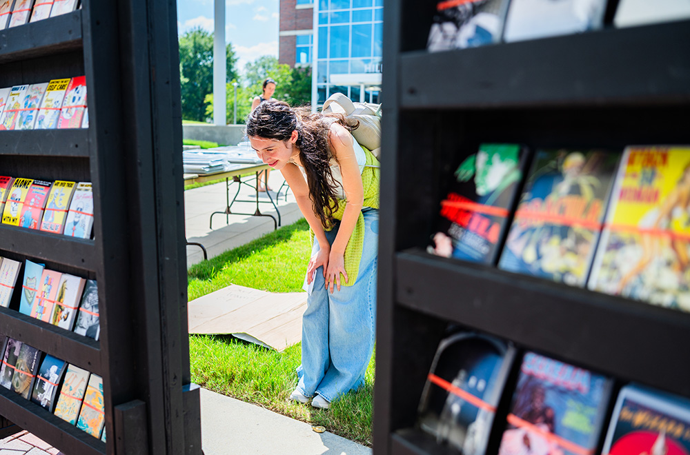 A student looks at posters outside the Hill University Center