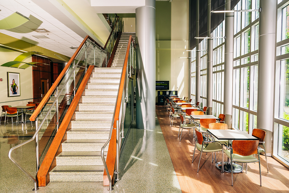 Empty staircase and tables on the ground floor of Heritage Hall