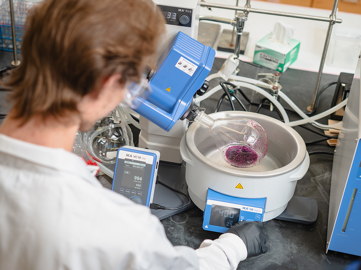 Researcher, seen from behind, operates equipment in a UAB lab