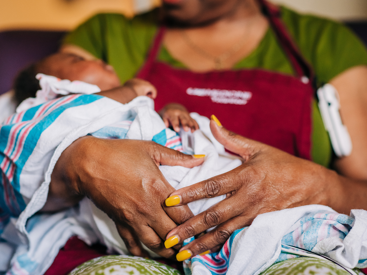 A Helping Hands volunteer rocks an infant in the UAB NICU