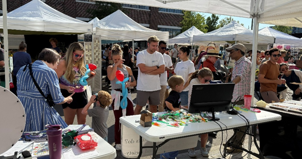 Large crowd visiting the SPAN booth at Pepper Place.