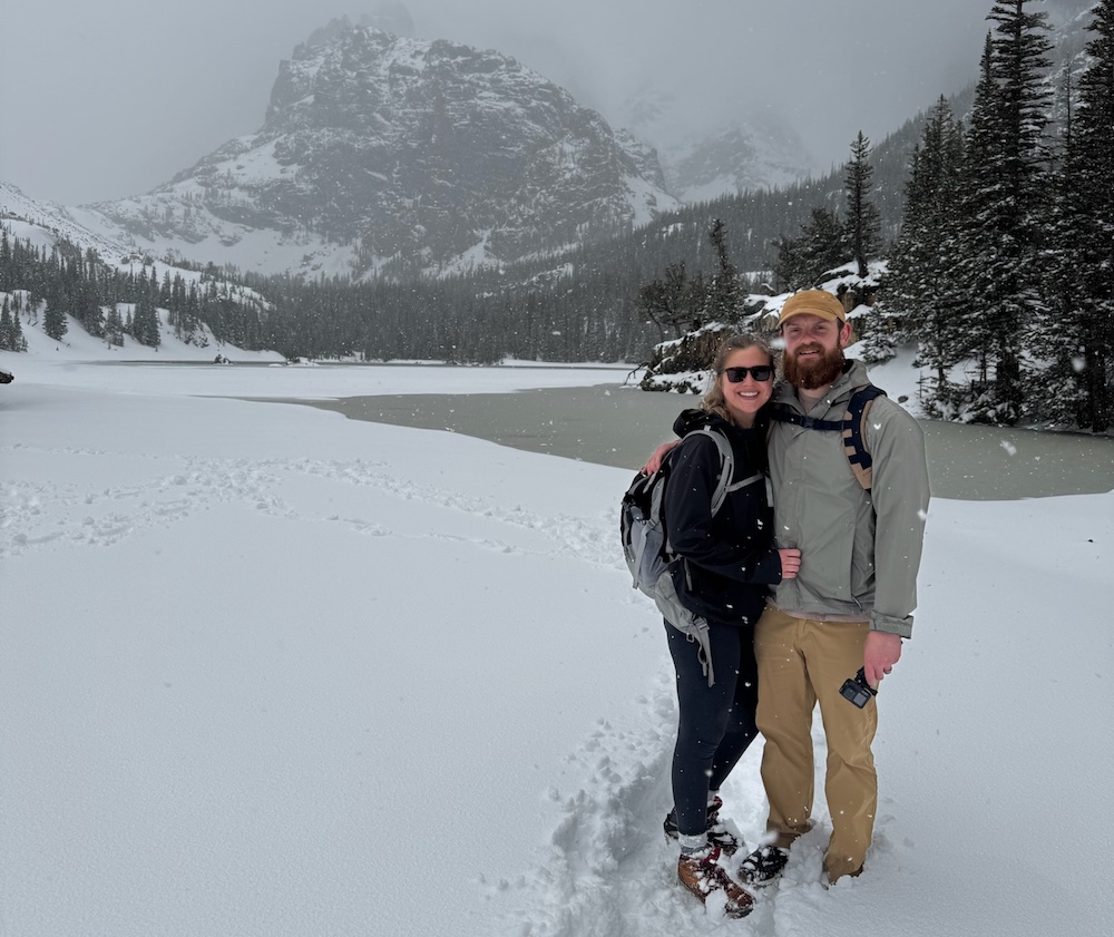 Bumpas poses standing in snow in front of a mountain.