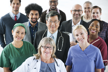 Group of people including professionals, nurses, doctors of varying ages, genders, and ethnicities. 