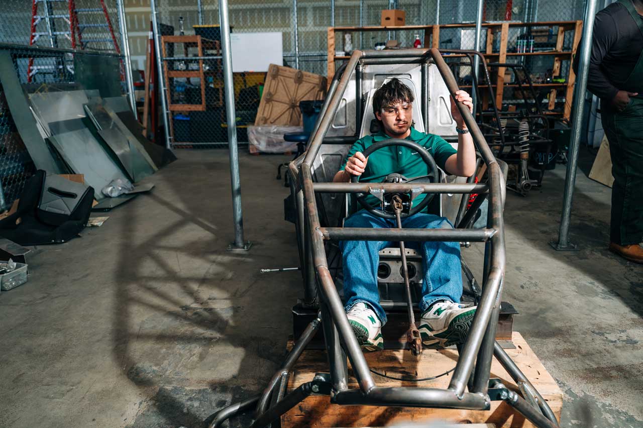 Hollingsworth sits inside a student-built Baja car frame.